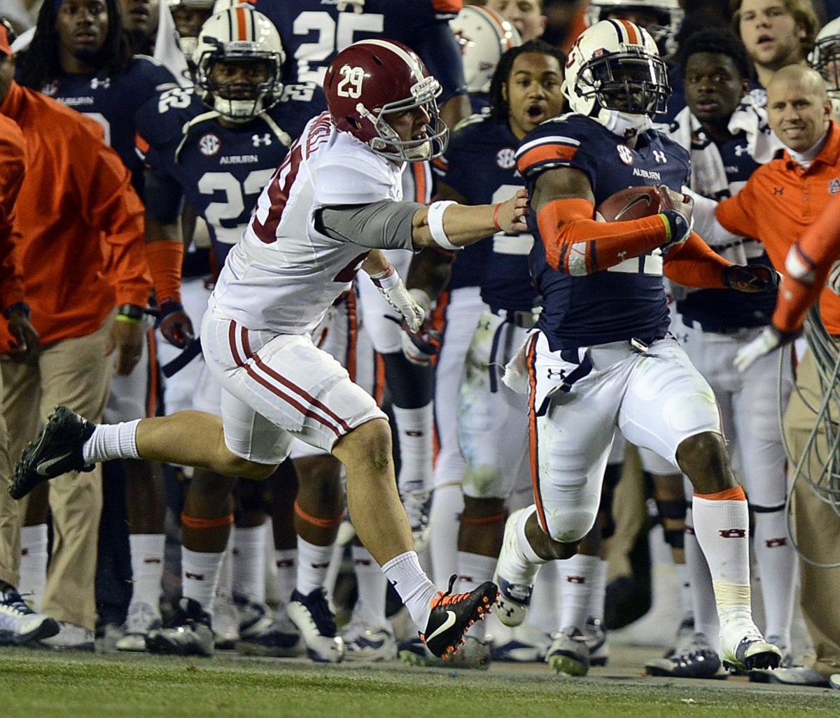 Alabama wide receiver Caleb Sims (29) grabs for Auburn cornerback Chris Davis (11) during the Iron Bowl at Jordan-Hare Stadium on Saturday, Nov. 30, 2013. Ironbowl2013no2